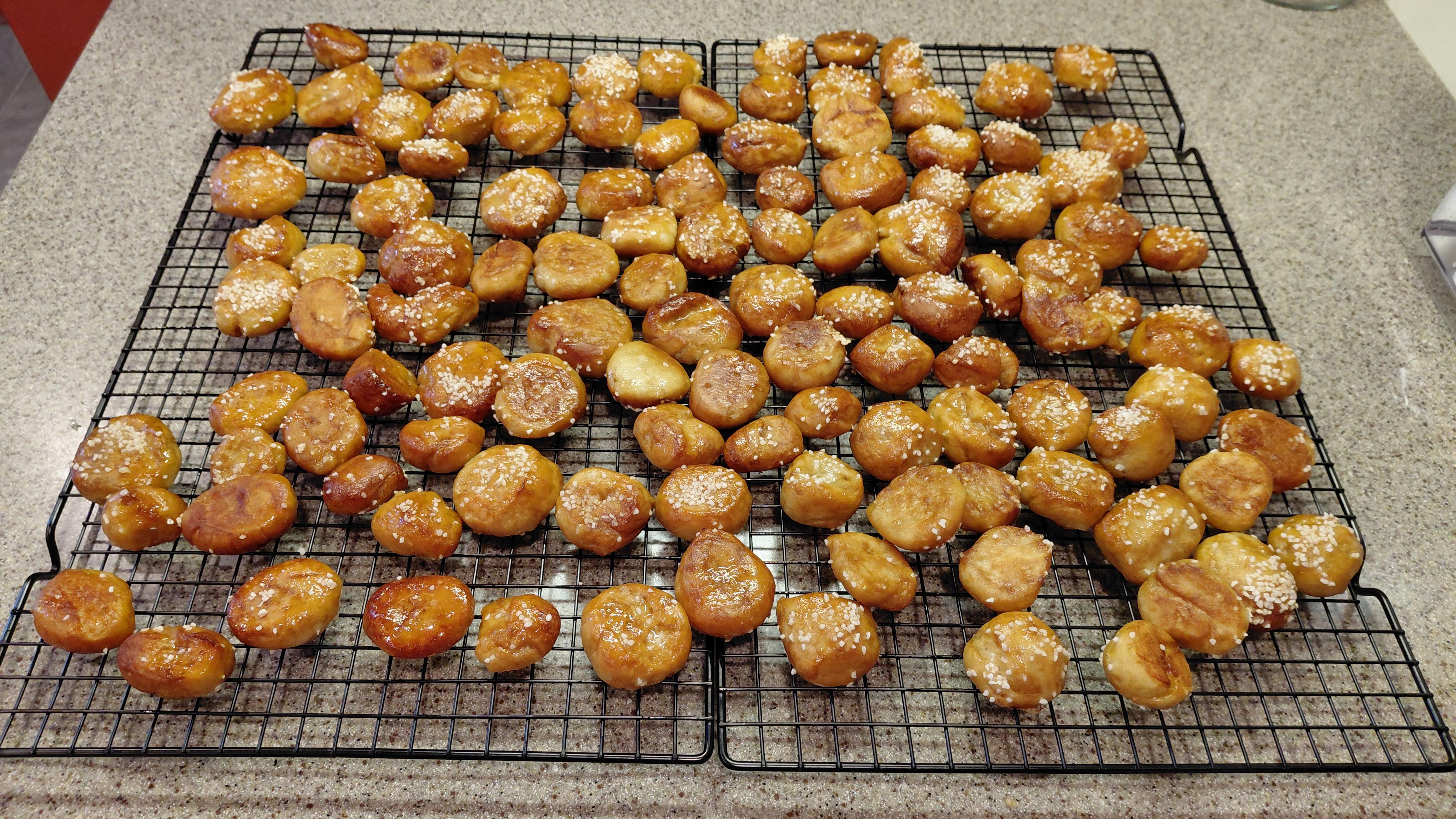 A board of mixed pretzel twists and buns with heavy parmesan finish