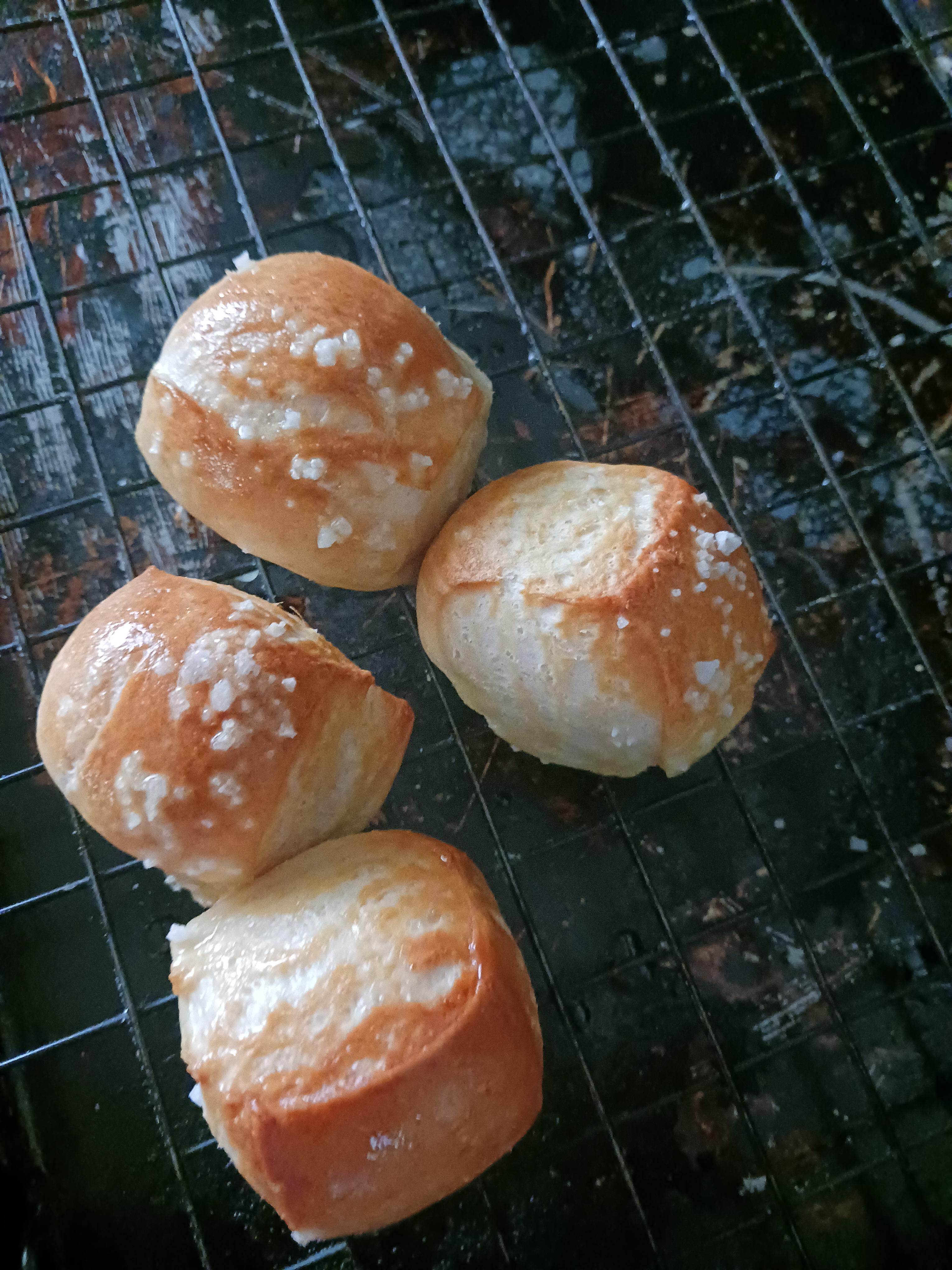 Massive spread of pretzel nuggets on two cooling racks, salted